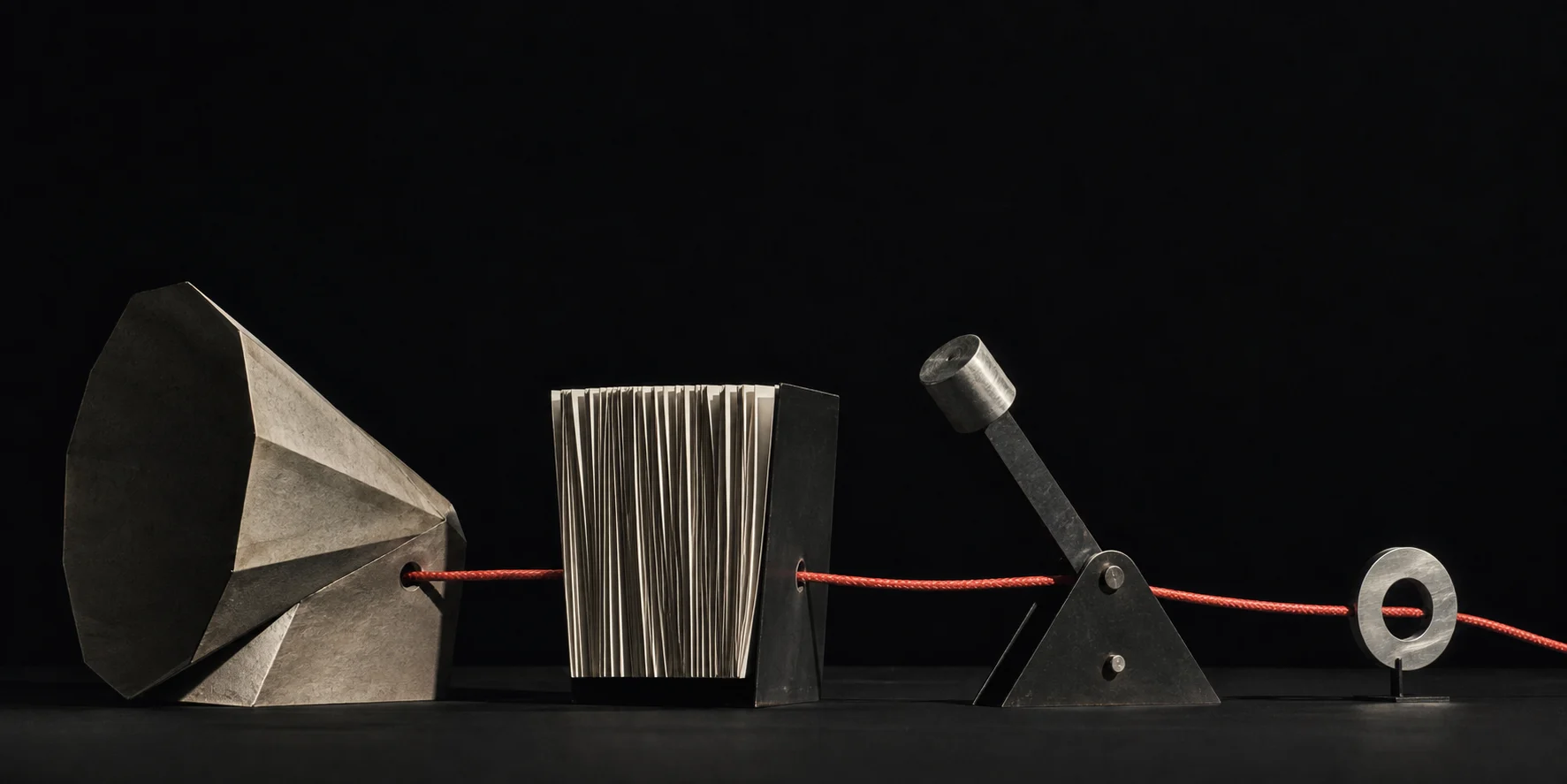 Four sculptural forms connected by one continuous coral signal cord